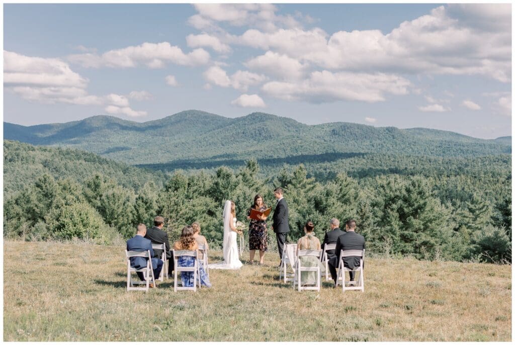 Adirondack elopement couple exchanging vows in front of 7 guests surrounded by mountains. Quality time is one of the reason why elopements are better than weddings.
