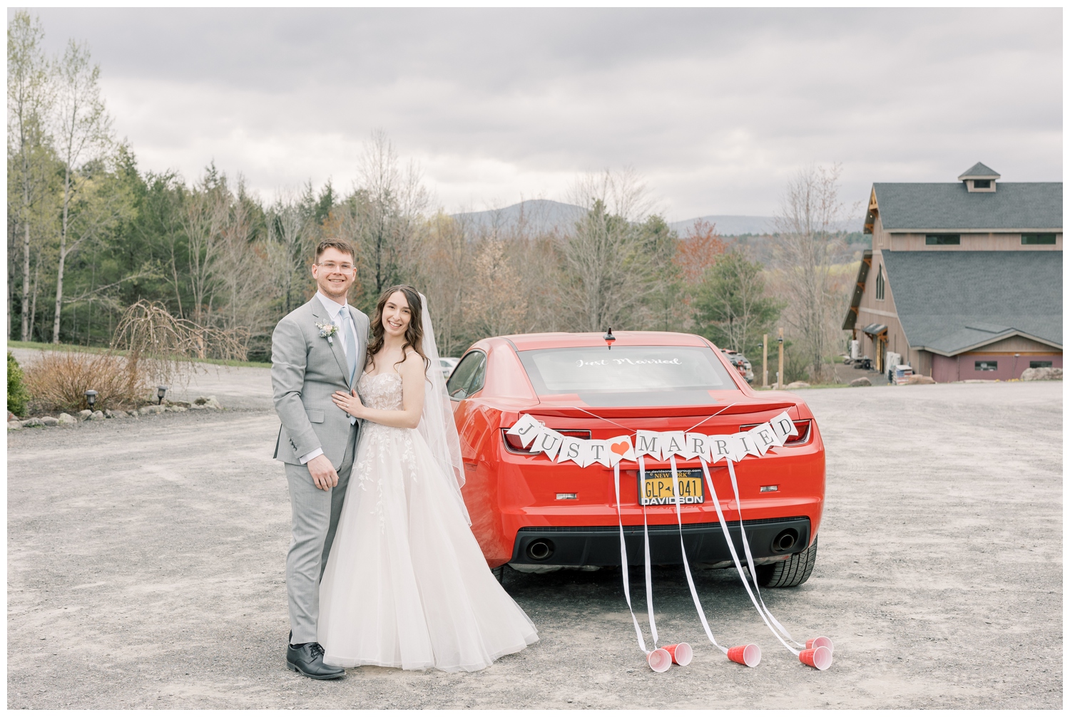 Bride and Groom standing next to their getaway car after getting married in the Enchanted Forest at Windham Manor.
