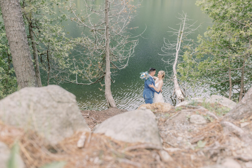 classy and elegan bride and groom elopement portrait in Adirondacks with a beautiful lake in the backdrop