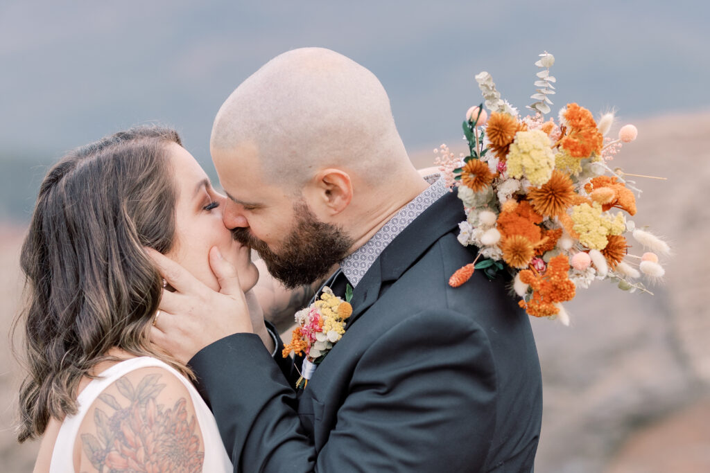 adventurous bride and groom elopement portrait in Adirondacks, bride and groom kissing