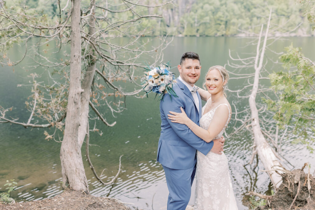 Bride and groom sharing a romantic moment by Lake George, celebrating their love with a weekday wedding elopement