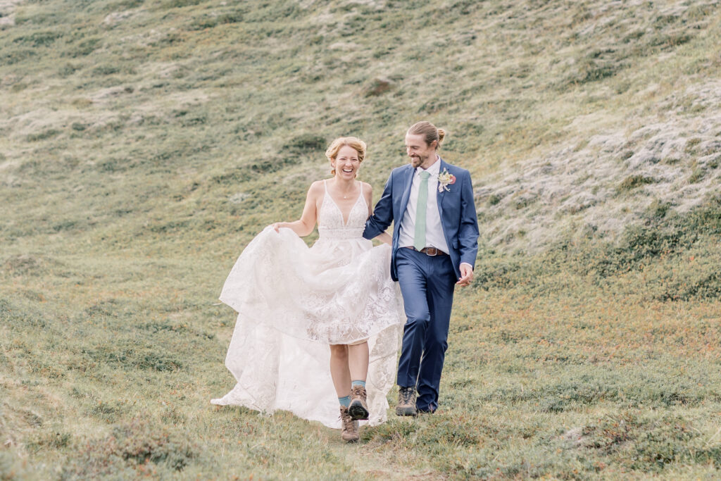 Bride and groom skipping and laughing together while wearing their wedding attire during their Adirondack elopement in Upstate New York.