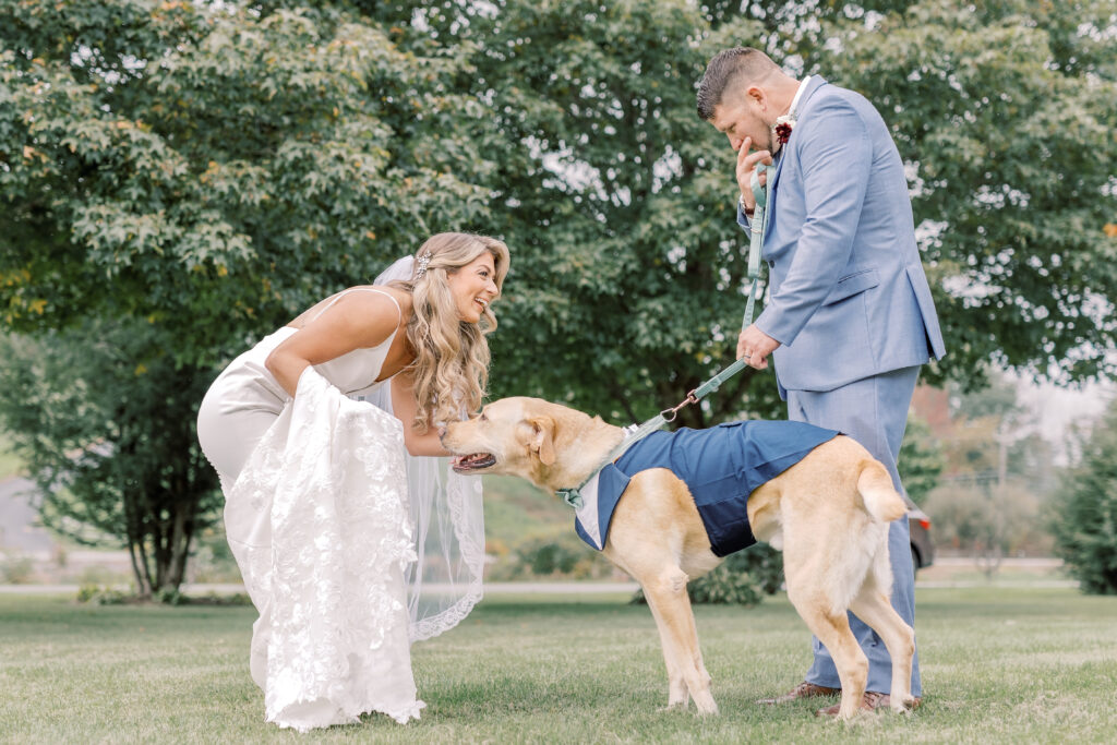 bride and groom cuddling their dog during their elopement day