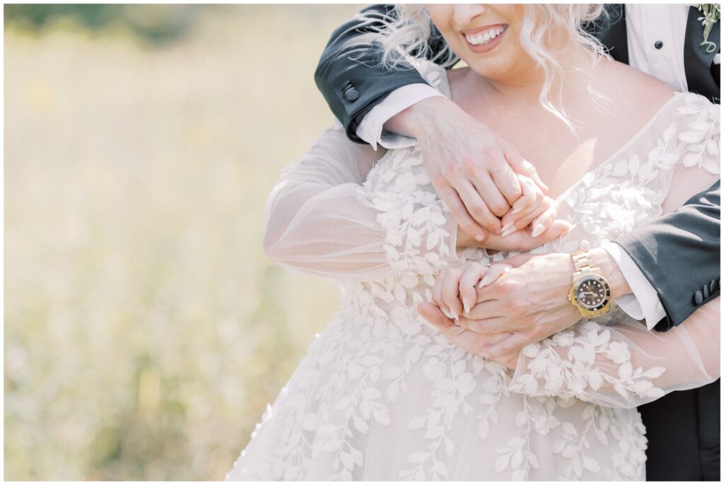 playful bride and groom portrait by lake placid