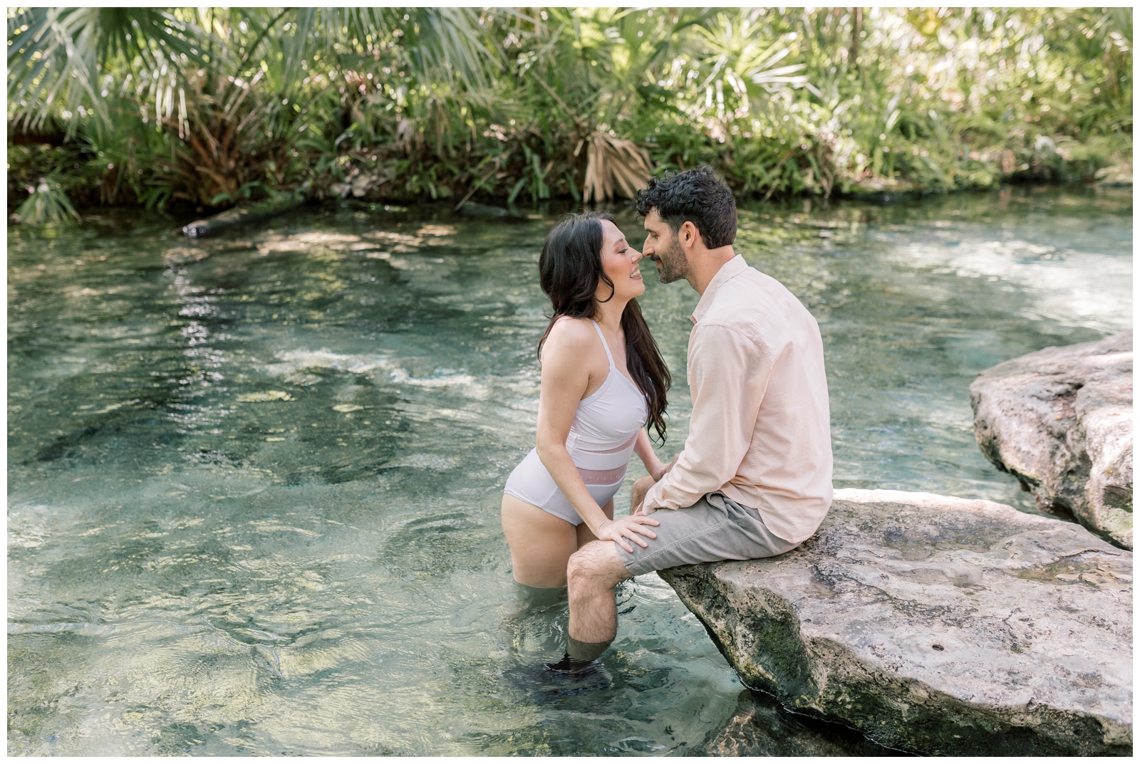 Couple swimming at Kelly Springs Park in Florida during their elopement in the Winter.