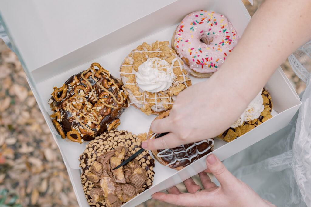 bride grabbing a delicious donut custom for elopement