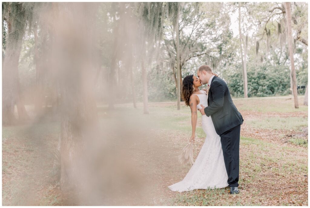 Wedding couple kissing at a local park in Crystal River during their Florida elopement.
