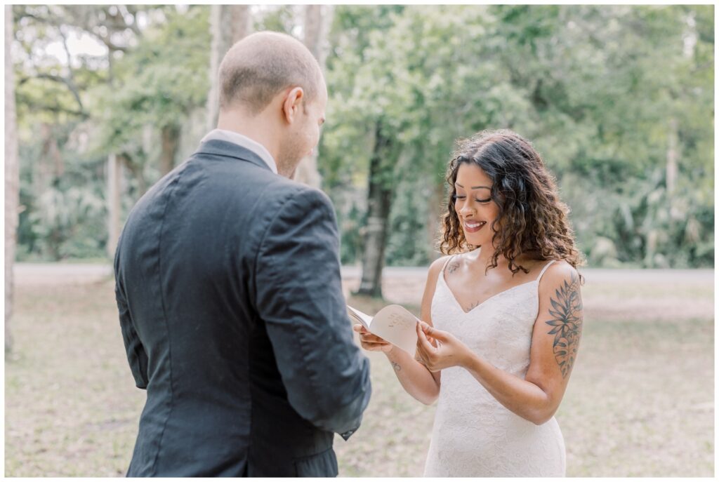 Bride reading Groom vows during their intimate ceremony with just the two of them.
