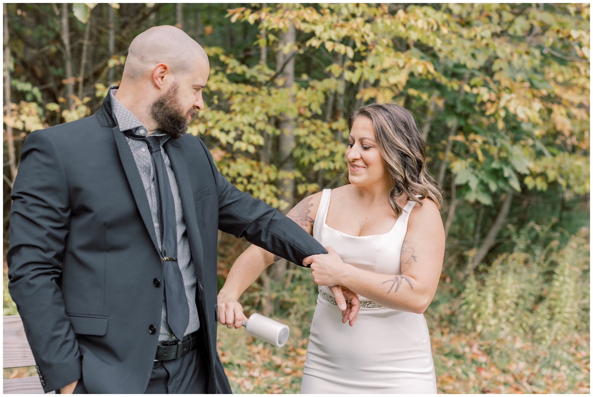 Bride helping her groom get ready during their Lake George Adventure Elopement.
