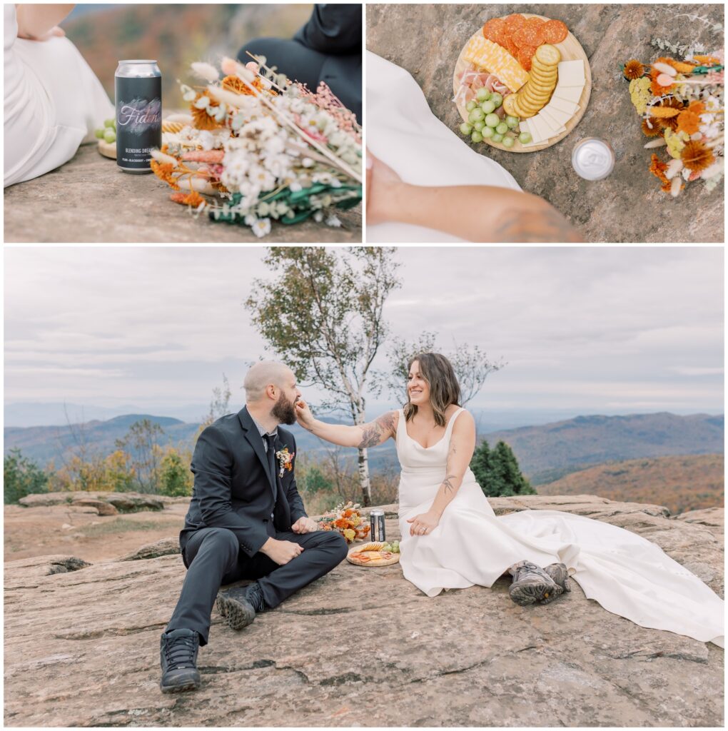 A bride and groom share a picnic at the summit of a mountain in Lake George in the Fall during sunset.
