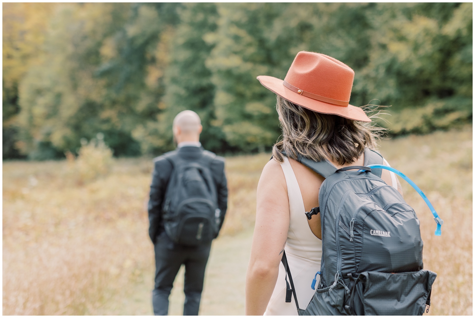 During an adventure elopement, this couple wore their wedding outfits as they hiked down a mountain.
