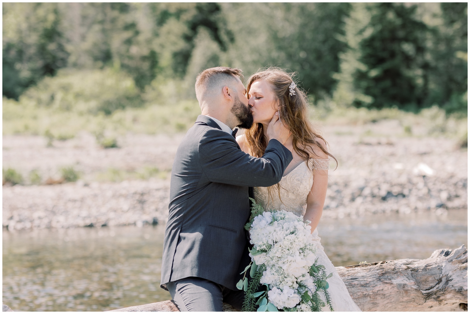 Bride and groom kissing in the woods on their wedding day during their adventure elopement.
