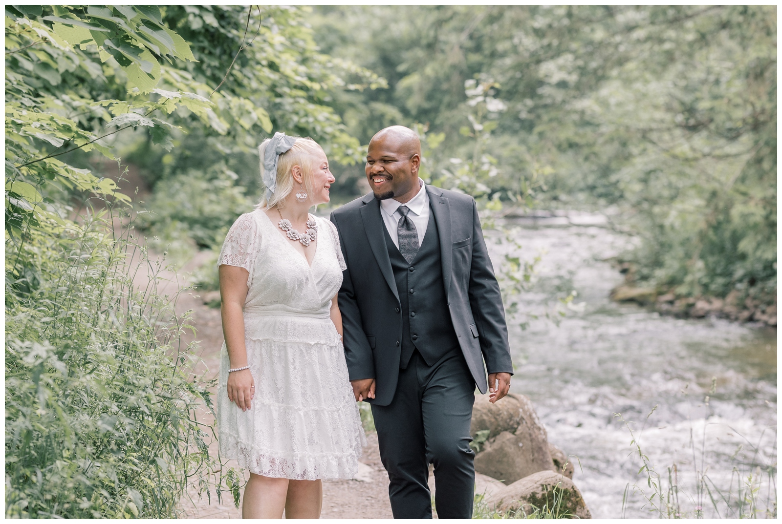 Interracial couple exploring Saratoga Spa State Park during their adventure elopement.