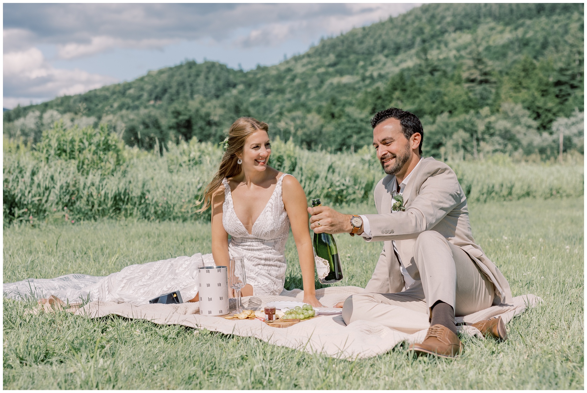 Bride and Groom sharing a picnic during their elopement in Keene Valley at Marcy Field.
