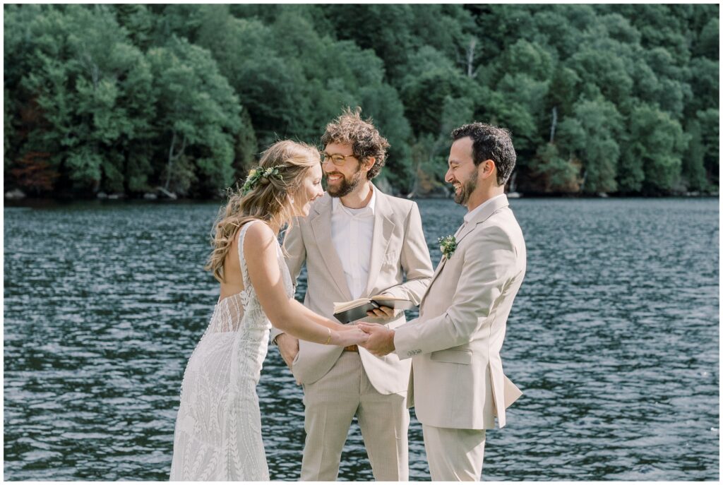 Couple laughing throughout their intimate ceremony by cascade lakes in the Adirondacks.
