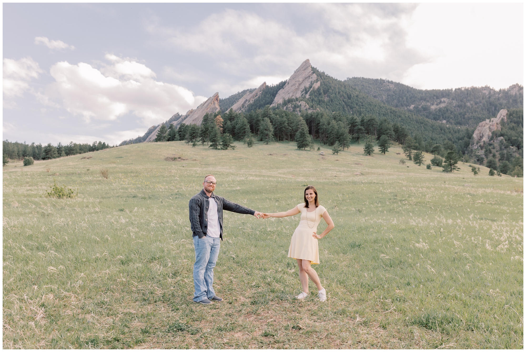 Couple posing with the flatirons in the background during their Boulder Anniversary Session.