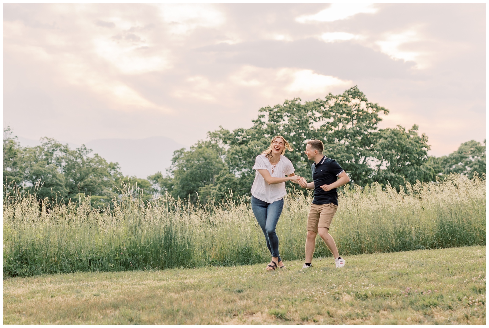 Couple laughing and having fun in an overgrown field.
