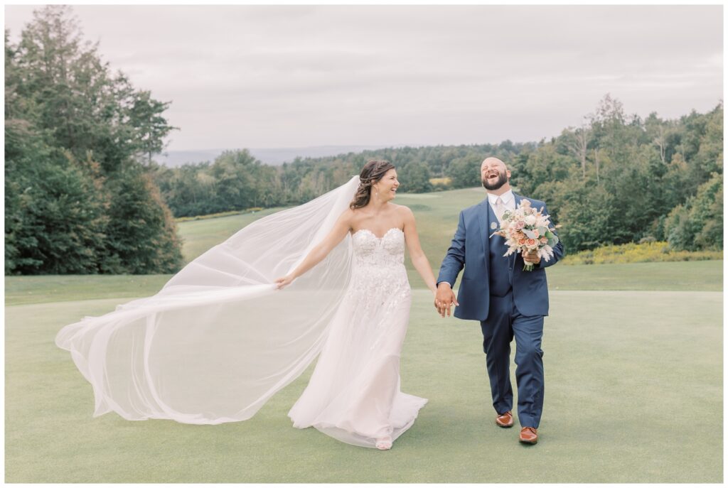 Wedding couple walking hand in hand at Saratoga State Park on their wedding day.
