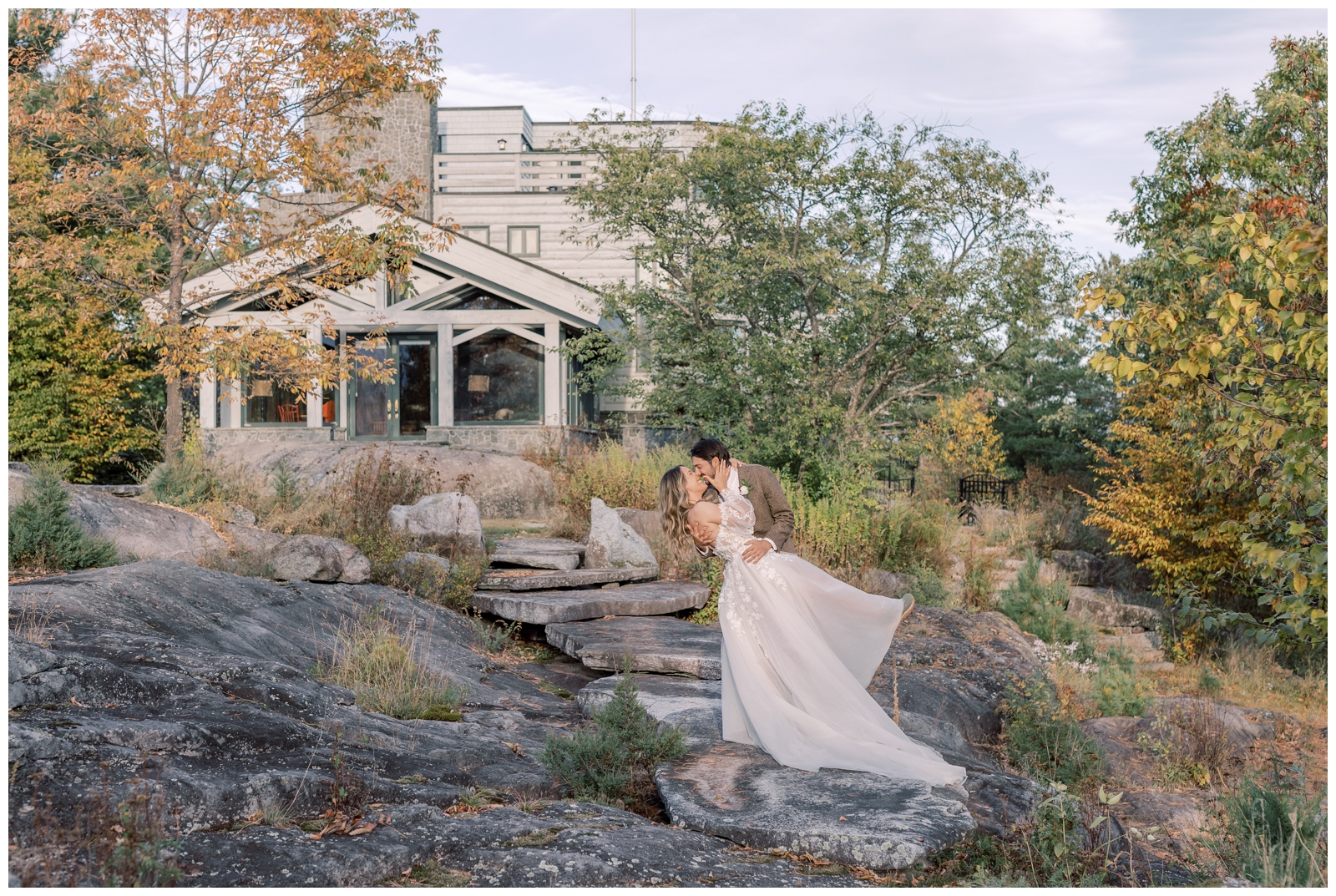 Wedding couple dipping each other as they kiss after their ceremony.