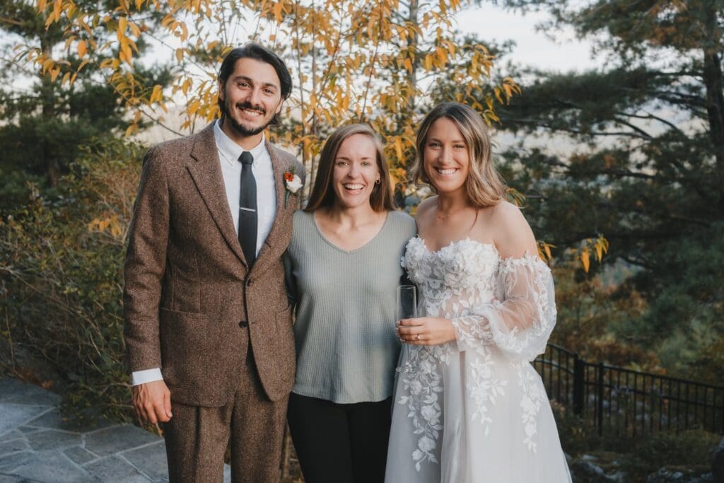 Elopement photographer smiling with the bride and groom. Here are some helpful tips for booking your elopement photographer.
