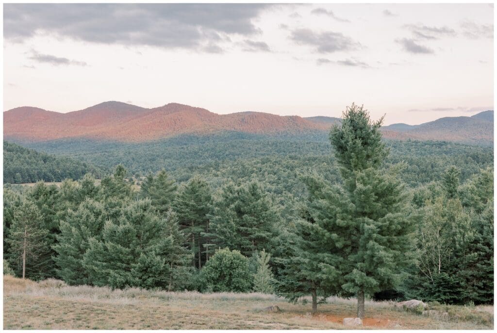 Golden hour Adirondack elopement portraits with mountains glowing at sunset.