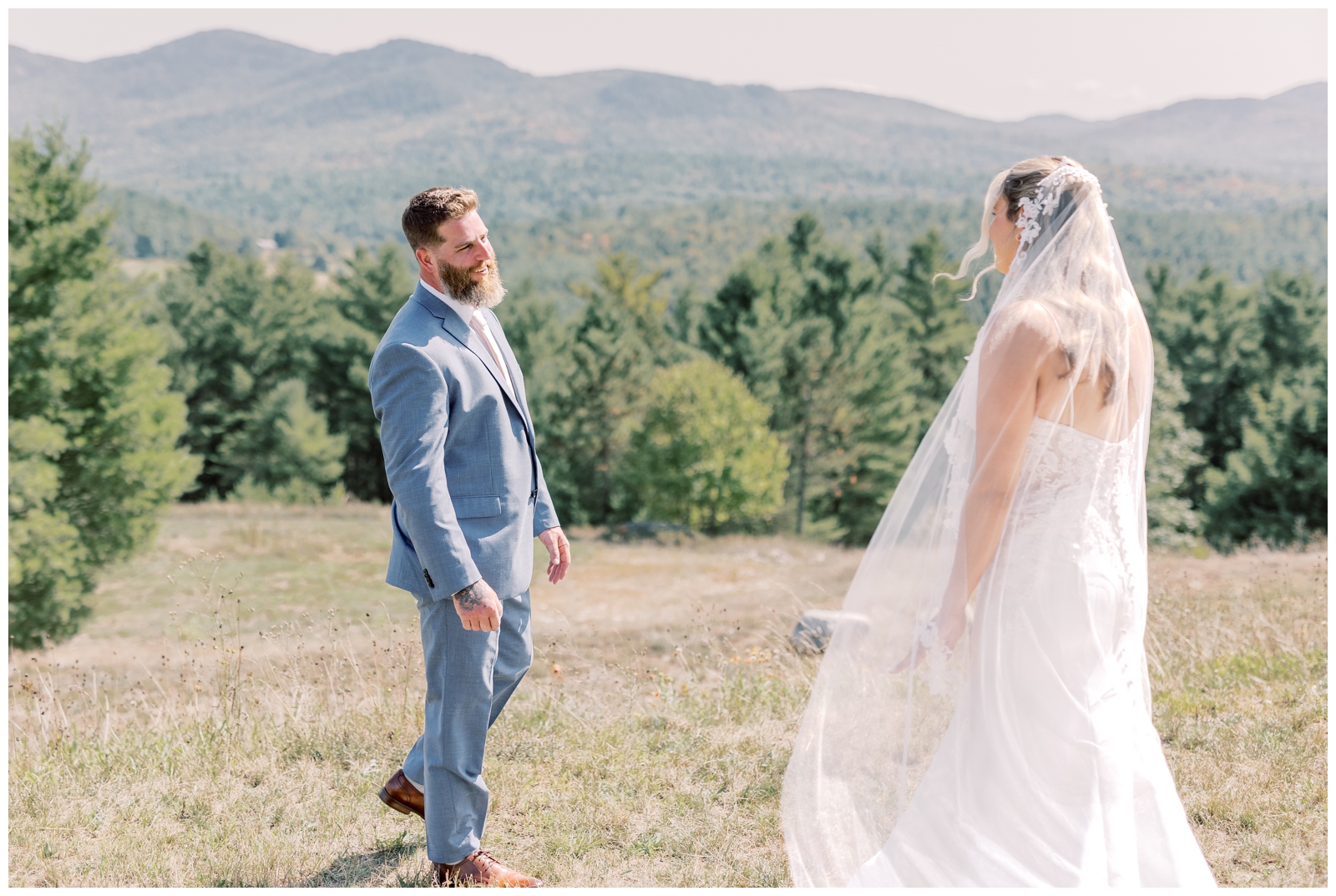Groom in blue suit seeing his bride for the first time during their intimate elopement in jay NY
