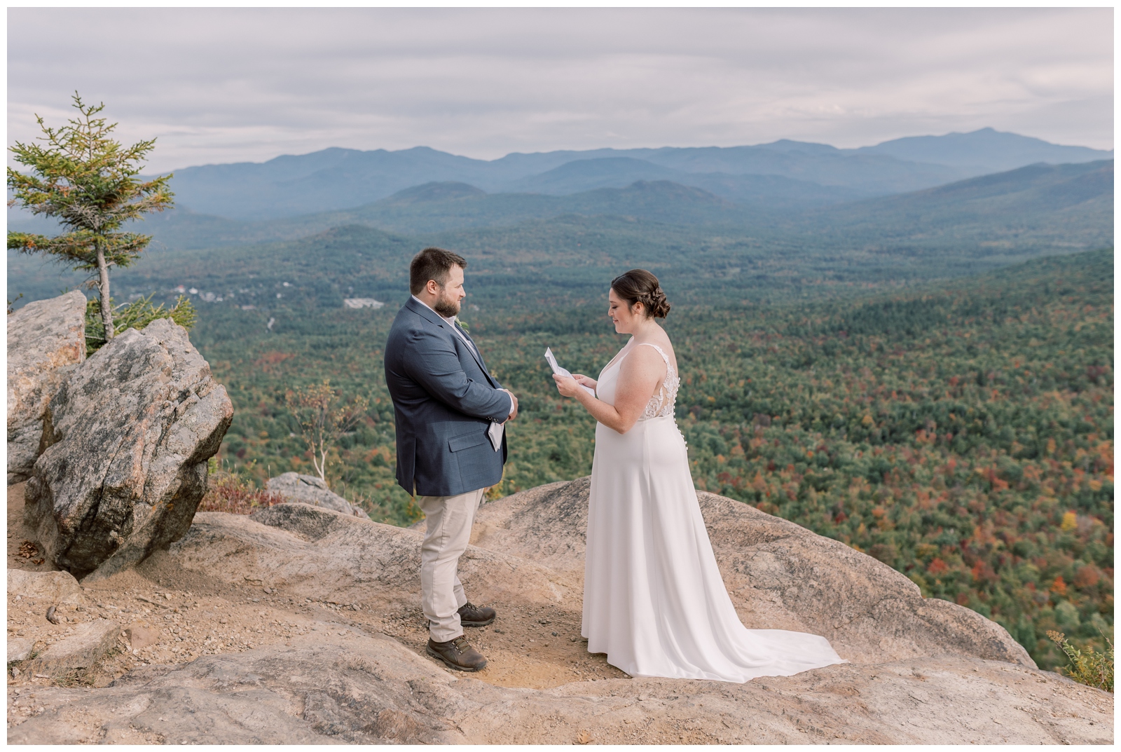 Couple sharing vows on top of a mountain over looking the high peaks during their fall foliage elopement in the Adirondacks.