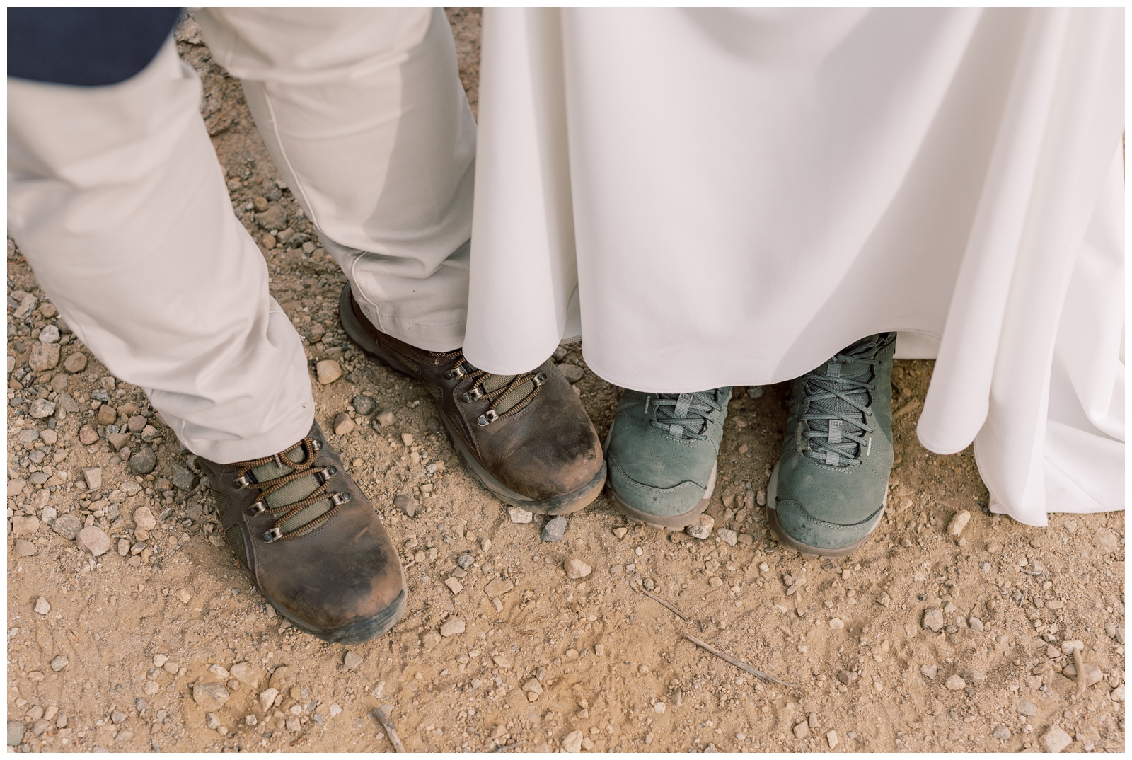 Bride and Groom in hiking boots and an elopement dress hiking up a mountain.