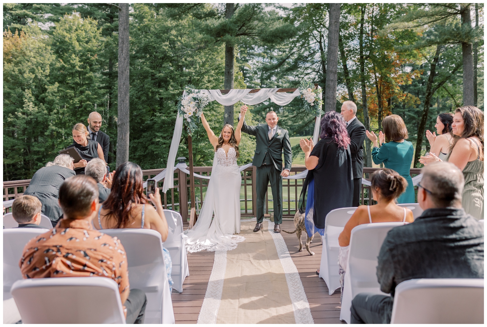 Bride and groom celebrating after just getting married in Lake George
